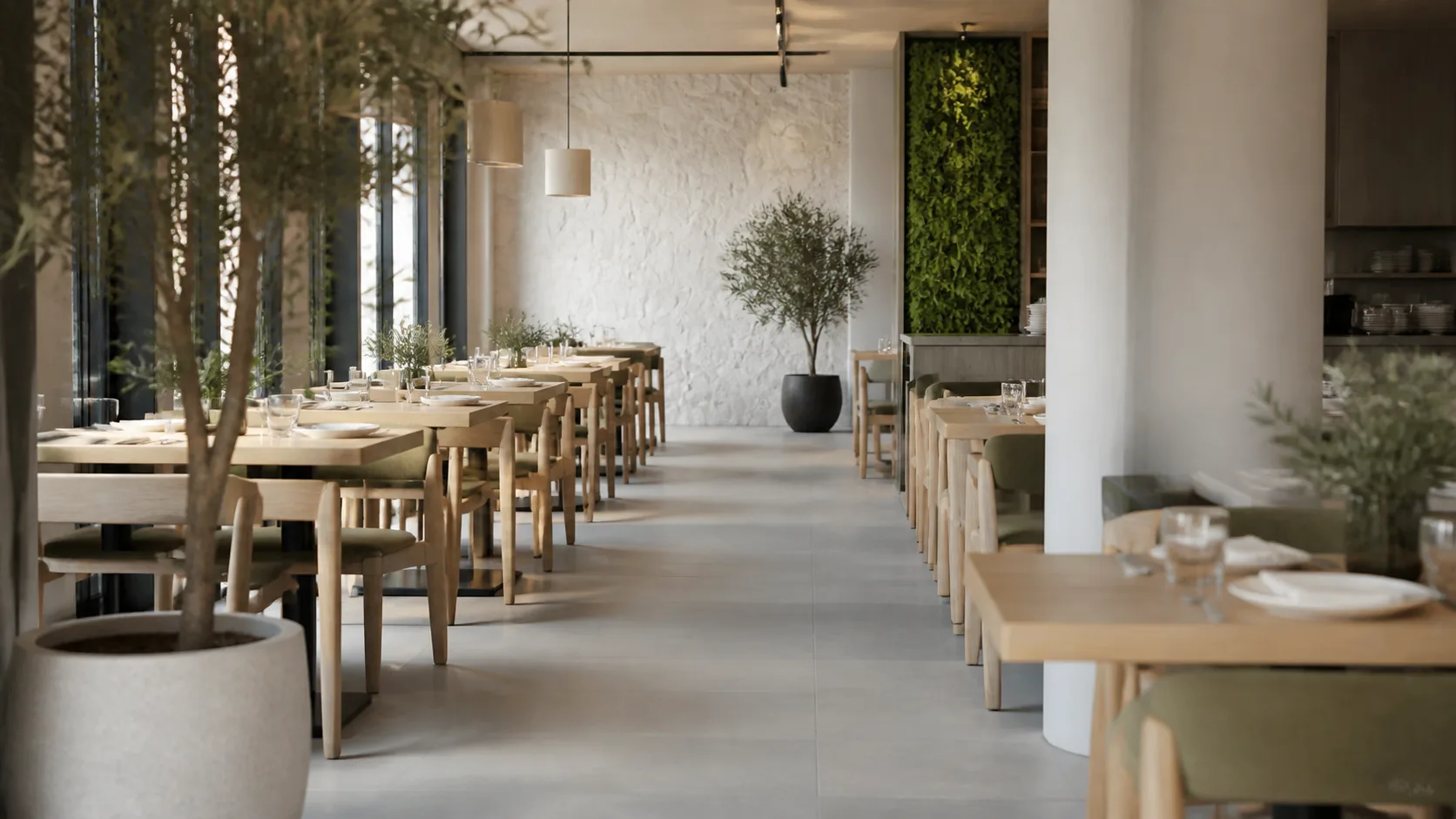 Salle de restaurant sobre avec une composition végétale artificielle au fond et une allée de service dégagée entre les tables.